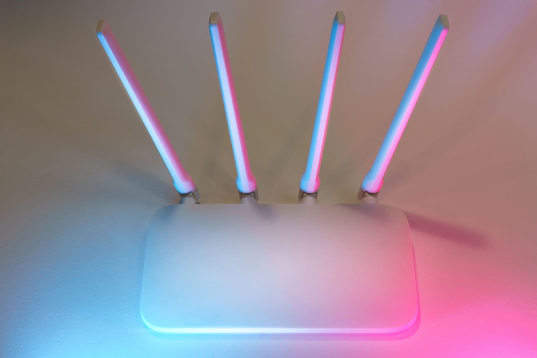 A white wireless router glowing with soft blue light