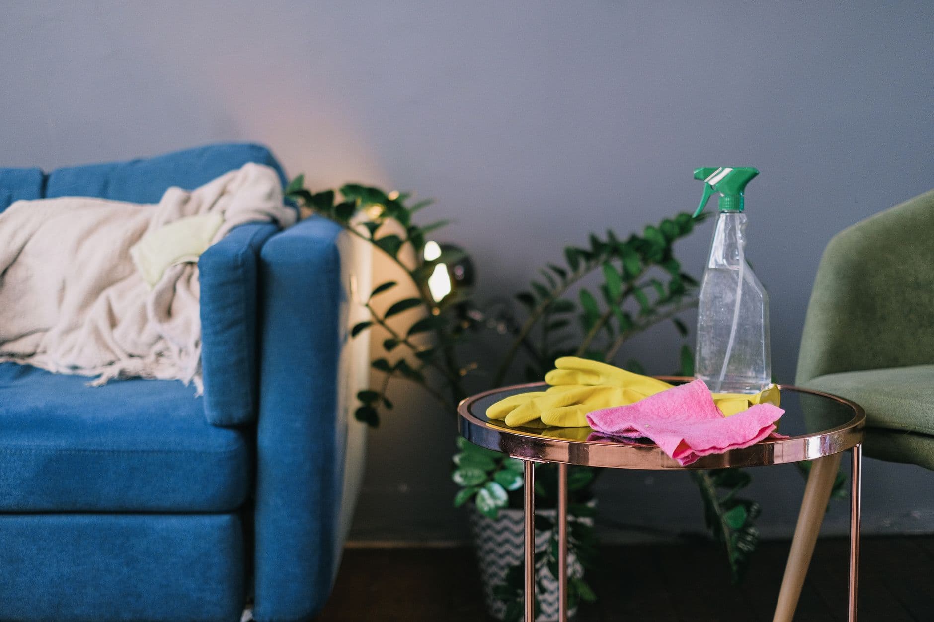 Cleaning gloves and spray detergent on a table in a living room