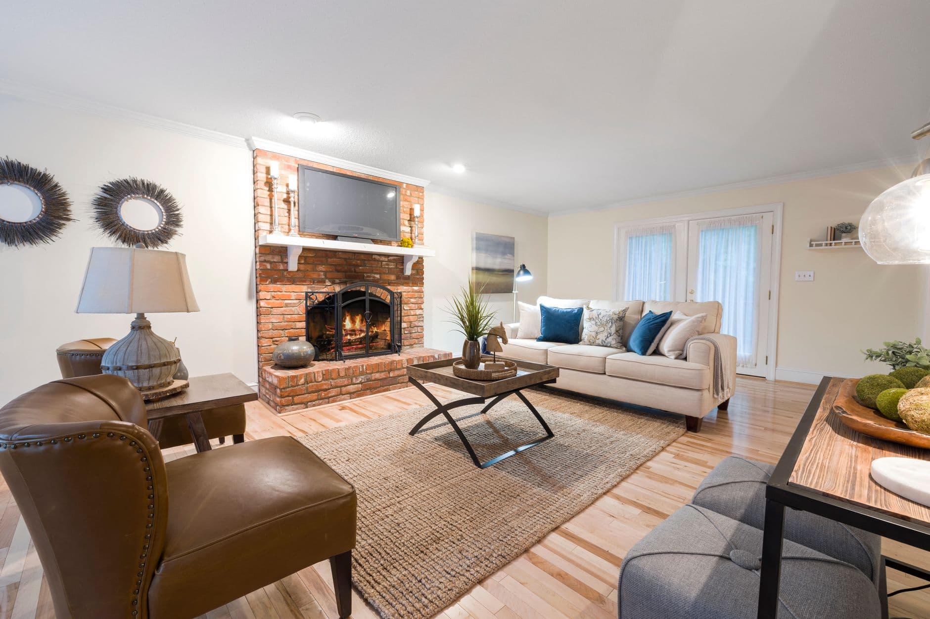 A cosy living room with a brick fireplace and comfortable seating