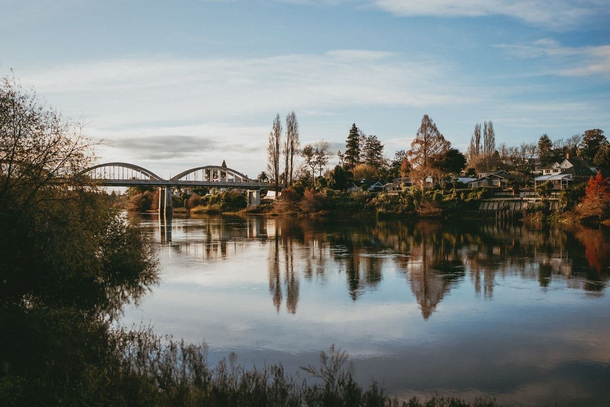 The Waikato River with Fairfield Bridge and riverside houses in Hamilton, New Zealand