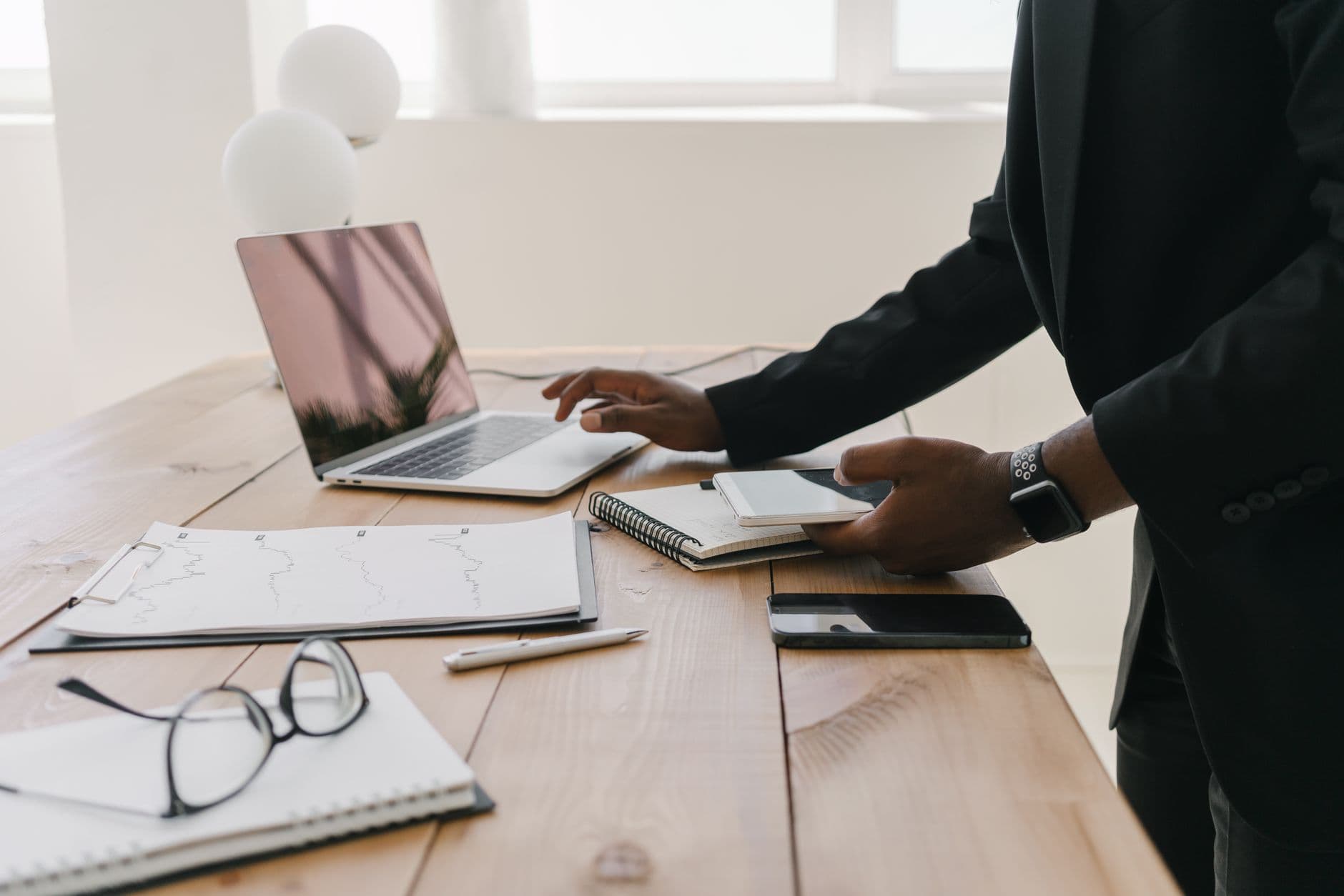 A laptop and paperwork laid out on a desk