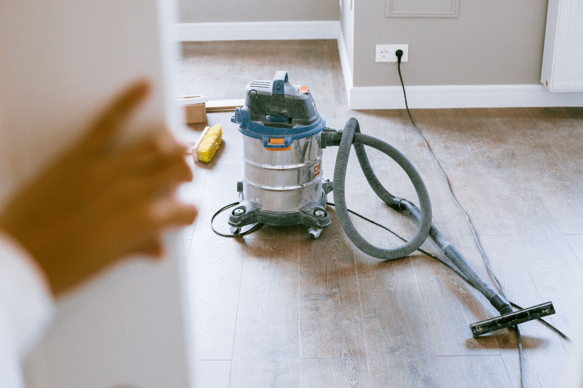 An industrial vacuum cleaner in a newly renovated, empty apartment