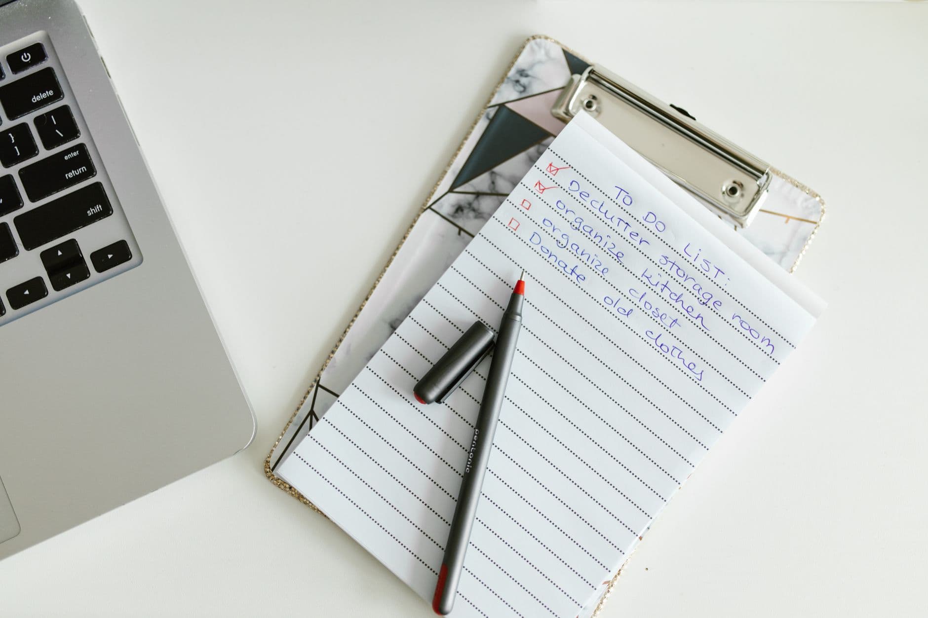 A clipboard checklist next to a laptop and pen, ready to plan a move