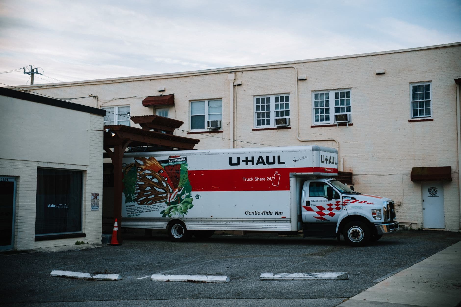 A U-Haul moving truck parked outside a warehouse